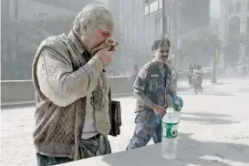  ?? AMY SANCETTA/ASSOCIATED PRESS FILE PHOTO ?? BELOW: A man coated with dust and debris from the collapse of the World Trade Center south tower Sept. 11, 2001, coughs near City Hall in New York.