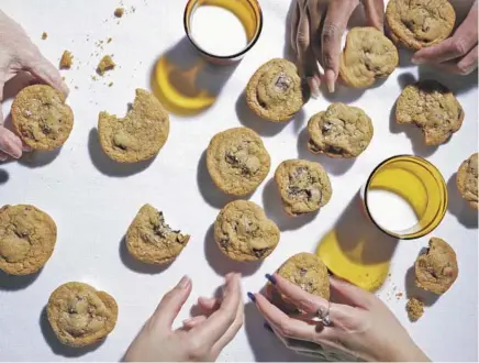  ?? Photograph­s by Stephanie S. Shih For The Times ?? LOS ANGELES, CA JANUARY 20, 2023: The Los Angeles Times test kitchen staff reach for chocolate chip cookies on January 20, 2023 at Los Angeles Times test kitchen in El Segundo, CA. The chocolate chip cookie is a featured recipe.