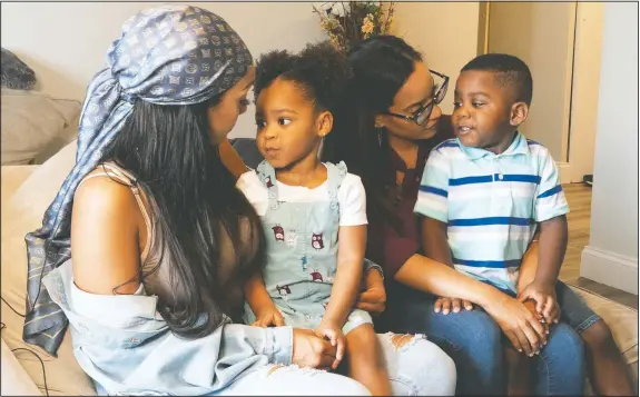  ?? (AP/Mary Altaffer) ?? Siblings Katherine (from left), Jazzmyn, Jennifer and Zavion Guzman talk about getting ice cream if the children behave in Newark, N.J. Their mother, Lunisol Guzman, who as a single mother raised three children and adopted two more in her late 40s, died of covid-19, leaving 4-year-old Zavion and 2-year-old Jazzmyn motherless. Guzman’s adult daughters, Katherine and Jennifer, have stepped up to raise the children their mother embraced in middle age.