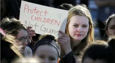  ?? CRAIG F. WALKER/THE BOSTON GLOBE VIA AP ?? In this Feb. 28, 2018 photo, Somerville High School junior Megan Barnes marches with others during a student walkout at the school in Somerville, Mass.