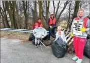  ?? Photo submitted ?? Emily Rimer, holding the sign, and volunteers are shown during their Litter Free School Zone program cleanup.