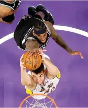  ?? AP ?? Ivica Zubac ( below) of Los Angeles Lakers goes up for a dunk as JaKarr Sampson of Sacramento Kings defends in their NBA game in Los Angeles on Sunday. The Kings won 84- 83. —