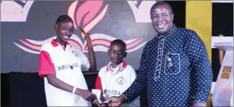  ?? ?? Winners of the first prize of Biblepaedi­a, Peace Victor and Justice Victor of RCCG: Seat Of Mercy, Ikorodu, receiving their cash prize from Chairman PFN Agege and Ogba Chapter, Bishop Praise Oliver.