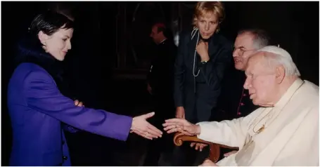  ??  ?? THIS PAGE, ABOVE: Pope John Paul II greets Dolores O’Riordan, lead singer of Irish pop group Cranberrie­s, at the Vatican on December 14, 2001