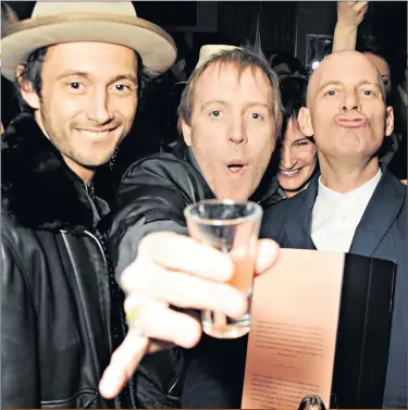  ??  ?? Having a grand time: Dan Macmillan, left, Rhys Ifans and Paul Rowe toast the Groucho