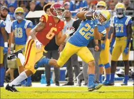  ?? Wally Skalij Los Angeles Times ?? UCLA CORNERBACK Nate Meadors intercepts a pass by USC’s JT Daniels intended for receiver Michael Pittman, left, in the second quarter.