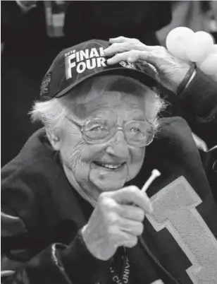  ?? Kevin C. Cox, Getty Images ?? Sister Jean Dolores Schmidt celebrates with the Loyola Ramblers after they defeated Kansas State 78-62 last weekend during the South Regional final.