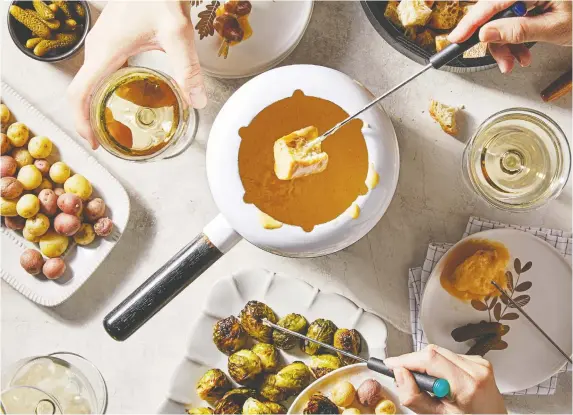  ?? TOM McCORKLE/FOR THE WASHINGTON POST ?? A fondue party may seem retro, but sharing a pot of melted cheese is a timeless (and delicious) experience.