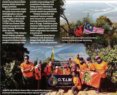  ??  ?? KUMPULAN OTiM dan Hawau Hiker mengabadik­an kenangan di puncak Gunung Santubong selepas tiga jam mendaki. SEORANG peserta mengibar Jalur Gemilang berlatar belakang Sungai Santubong.