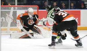  ?? NEWS PHOTO RYAN MCCRACKEN ?? Edmonton Oil Kings centre Scott Atkinson is stopped by Medicine Hat Tigers goaltender Mads Søgaard while Cole Clayton defends during the first period of Saturday’s Western Hockey League game at the Canalta Centre.