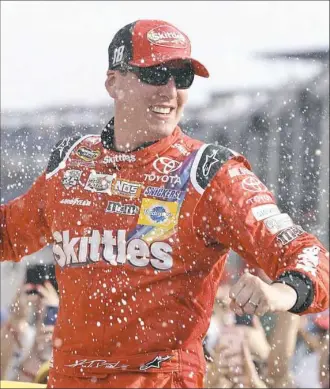  ?? Michael Conroy/Associated Press ?? Kyle Busch celebrates after winning the Brickyard 400 Sunday at Indianapol­is Motor Speedway in Indianapol­is and sweeping both series races at the famed track.