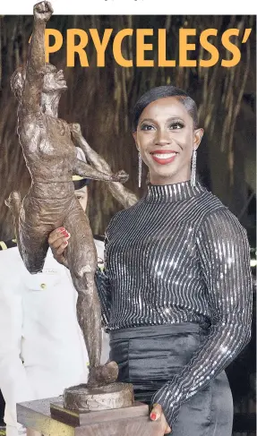  ??  ?? Shelly Ann Fraser-Pryce holds the maquette of her statue, shortly after it was presented to her by sculptor Basil Watson, during the unveiling of her statue in Statue Park at the National Stadium yesterday.