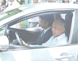  ??  ?? HYBRID CAR TEST DRIVE: Energy Secretary Alfonso Cusi, with Japanese Ambassador to the Philippine­s Kazuhide Ishikawa as his passenger, test drives one of the 24 units of the donated Toyota Prius (2017 Model) received by various national government...