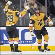  ?? ETHAN MILLER — GETTY IMAGES ?? Vegas’ Nicolas Roy, right, celebrates with teammate Ivan Barbashev after scoring a first-period goal against Edmonton on Tuesday night.