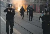  ?? Daniel Cole Associated Press ?? OFFICERS advance on marchers protesting police brutality and racism Saturday in Marseille, France.