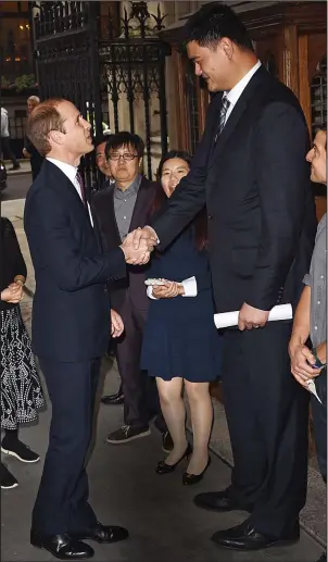  ??  ?? Meet and greet: 6ft 3in Prince William speaks to Yao MIng, who is 7ft 6in