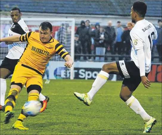  ?? Pictures: Steve Terrell ?? Alex Flisher attempts to play the ball while under pressure against Boreham Wood