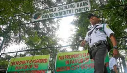  ?? MARIANNE BERMUDEZ ?? A guard secures the gated area used by Manila Seedling Bank Foundation, in this file photo taken on July 10, 2012, after the property was seized by the Quezon City government.—