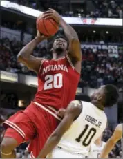  ?? DARRON CUMMINGS — THE ASSOCIATED PRESS ?? Indiana’s De’Ron Davis (20) shoots over Notre Dame’s TJ Gibbs (10) during the first half of an NCAA college basketball game, Saturday in Indianapol­is.