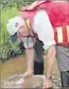  ?? ASHLEY FITZPATRIC­K/THE TELEGRAM ?? Peter Dimmell pans for gold in a small tributary near Foxtrap.