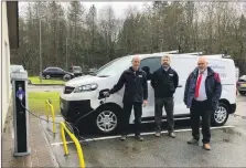  ?? ?? Joiner Anthony Wright connects the first charger from the new service point in Oban to an electric van, accompanie­d by Lee Holness, operations manager west, and Alastair MacGregor, the ACHA group chief executive.