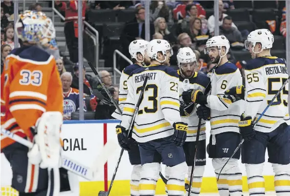  ?? IAN KUCERAK ?? Buffalo’s Ryan O’Reilly, centre, celebrates a goal with teammates during their 5-0 pasting of the Oilers on Tuesday at Rogers Place.