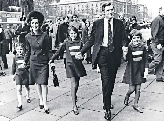  ??  ?? Into the limelight: Mary, centre, holds the hands of parents Cecil and Ann Parkinson as they arrive at the Commons in 1970. Below, Mary, right and her sister Joanna with their father in 1994