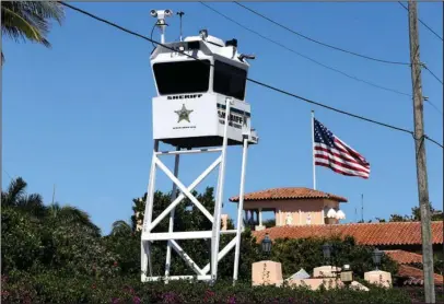  ??  ?? WATCHTOWER: A Palm Beach County Sheriff’s lookout tower sits outside of President Donald Trump’s Mar-a-Lago resort Friday in Palm Beach, Fla. Commission­ers in Palm Beach County are so tired of spending money on Trump’s frequent visits some are...