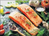  ??  ?? POSITIVE NUTRITION: Fresh salmon fillet with aromatic herbs, spices and vegetables, a balanced diet and cooking concept