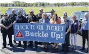  ?? BILL LACKEY / STAFF ?? Members of area law enforcemen­t and the Clark County Combined Health District took part Thursday in the Click It or Ticket campaign kickoff, encouragin­g anyone in a car to wear a seatbelt.