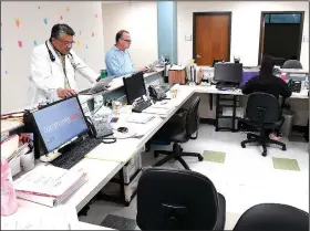  ?? NWA Democrat-Gazette/J.T. WAMPLER ?? Dr. Sheldon Riklon (left) works Friday at the Community Clinic in Springdale. Riklon splits his time between being an associate professor at the University of Arkansas for Medical Sciences and seeing patients at the clinic.