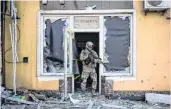  ?? ?? A soldier exits a damaged building after shelling in Kyiv