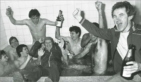  ?? PICTURE: PA Images ?? MAKING A SPLASH: Bournemout­h players in the bath as they celebrate beating Manchester United with assistant manager Stuart Morgan, right