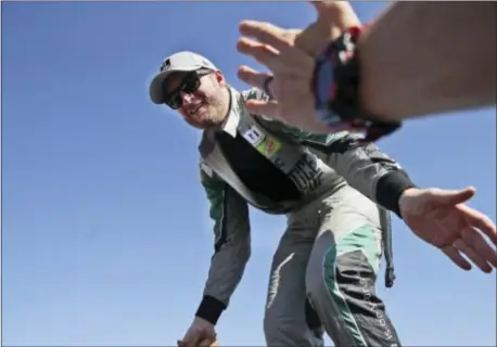  ?? THE ASSOCIATED PRESS ?? Dale Earnhardt Jr. reaches to fans during driver intros before the NASCAR Series Cup auto race at Texas Motor Speedway on Nov. 5.