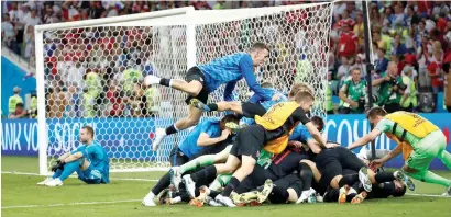  ?? Reuters ?? Croatia’s Ivan Rakitic celebrates with teammates after scoring the deciding penalty against Russia. —
