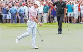  ?? Curtis Compton The Associated Press ?? Rory Mcilroy exults in front of Brooks Koepka after sinking a birdie putt on the final hole of the Tour Championsh­ip on Sunday at East Lake Golf Club in Atlanta.