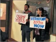  ?? NICHOLAS BUONANNO — NBUONANNO@TROYRECORD.COM ?? Community members hold up signs outside of the Rensselaer County Legislatur­e Chambers Tuesday night opposing Sheriff Patrick Russo’s 287(g) program with ICE.