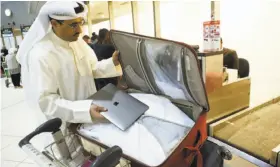  ?? Yasser Al-zayyat / AFP / Getty Images ?? U.S.-bound internatio­nal fliers from Kuwait like social media activist Thamer al-Dakheel Bourashed have had to put their laptops inside checked luggage.