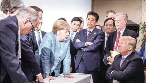  ?? — Reuters ?? German Chancellor Angela Merkel speaks to US President Donald Trump during the second day of the G7 meeting in Charlevoix city of La Malbaie, Quebec.