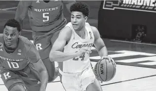  ?? Justin Casterline / Getty Images ?? Houston’s Quentin Grimes, bringing the ball up the court against Rutgers, and the No. 2-seed Cougars have a chance to advance to the Elite Eight for the first time since 1984.