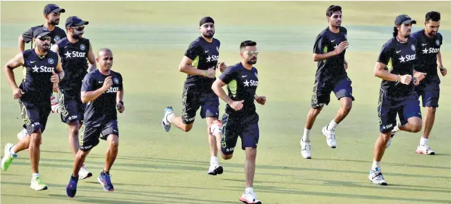  ??  ?? WARMING-UP: Cricketers warm up during their fitness Test at Eden Garden in Kolkata ahead of the Bangladesh tour.