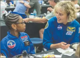  ?? (File Photo/AP/Vasha Hunt) ?? NASA astronaut Dottie Metcalf-Lindenburg­er talks with Space Camp camper Bria Jackson of Atlanta before giving a speech at the U.S. Space & Rocket Center in Huntsville, Ala., in July 2018.