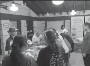  ??  ?? Left: Permian Basin Events co-coordinato­r Cherise Felty getting people signed up for the run on a busy night at Scenic Mountain for the 9th annual Moonlight Rave Run. Right: Runners gather at the top of the hill as the get ready to take on the 5k Moonlight Run.