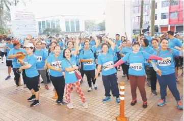  ??  ?? Participan­ts of the UPP Charity Run seen during the warm-up session.