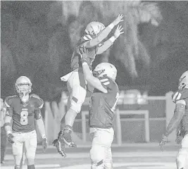  ?? MICHAEL LAUGHLIN/SUN SENTINEL ?? St. Thomas Aquinas running back Anthony Hankerson celebrates scoring a touchdown with offensive lineman Ryan Mickow during their game against Western on Sept. 24. The Raiders face Cardinal Gibbons on Saturday.