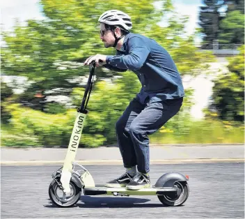  ?? PHOTO: PETER MCINTOSH ?? Otago Daily Times reporter Tim Miller gains a full head of speed while taking an escooter for a test ride around Northeast Valley this week.