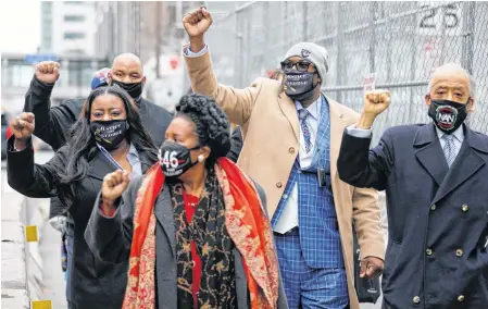  ?? REUTERS ?? The Floyd family and Rev. Al Sharpton gesture as they arrive at the Hennepin County Government Center for closing statements in the trial of former police officer Derek Chauvin, who is facing murder charges in the death of George Floyd, in Minneapoli­s, Minn. on Monday.