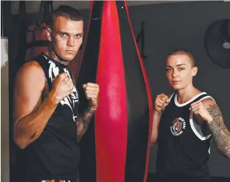  ?? Picture: KERI MEGELUS ?? Kickboxing couple Eddie and Brooke Farrell square up. Eddie was crowned the World Muay Thai Council light heavyweigh­t champion last week.