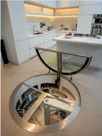  ??  ?? The glass trap door opening up to this expansive wine cellar is in the kitchen floor of a traditiona­l villa remodelled by Jessop Architects.