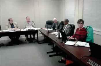  ?? (Photo by Charlie Benton, SDN) ?? Board members and SOCSD staff converse at the School Board meeting Tuesday night. The board approved the second half of the state’s $10 million contributi­on to the Partnershi­p School by a vote of 3-0.